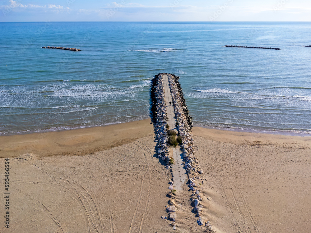 Lanscape aerial view, Italy Pescara. Empty beach, waves, sea, coast, sand, rocks.
