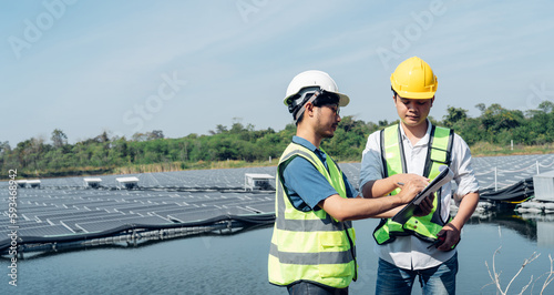 Team of engineers wearing a uniform inspect and check solar cell panel, solar cell is smart ecology energy sunlight alternative power factory concept.