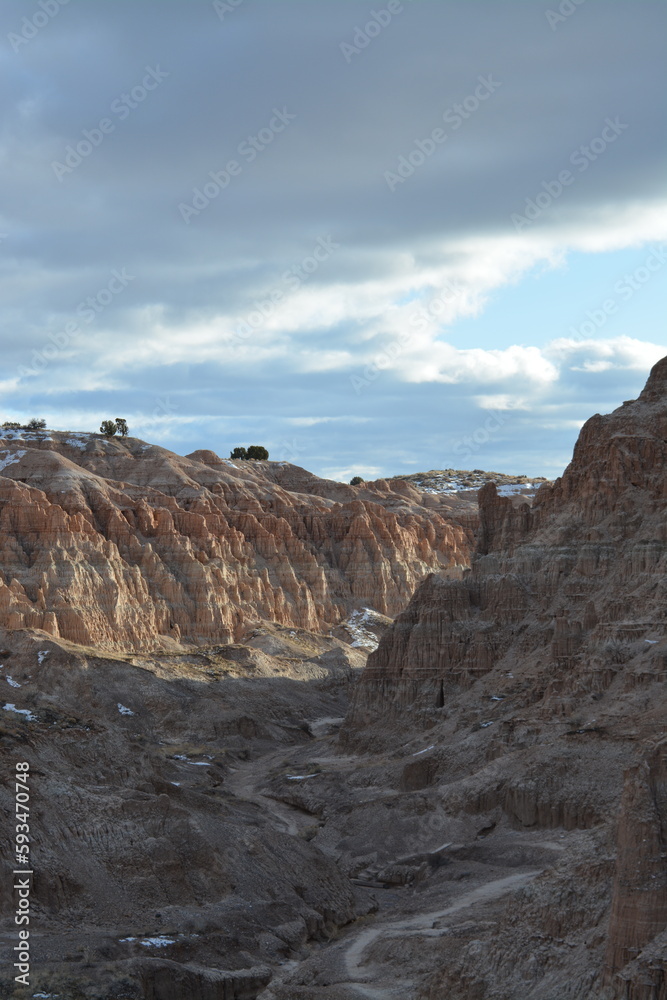 Cathedral Gorge State Park on a cold day in December with fresh snow, located in a long, narrow valley in southeastern Nevada, where erosion has carved patterns in bentonite clay