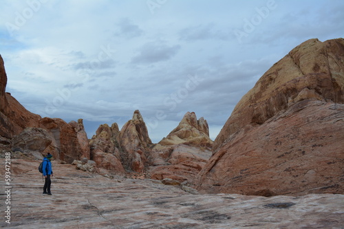 beautiful scenery of red sandstone, a man hiking Valley of Fire State Park in Nevada, USA