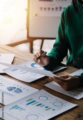 Financial analysts analyze business financial reports on a digital tablet planning investment project during a discussion at a meeting of corporate showing the results of their successful teamwork. photo