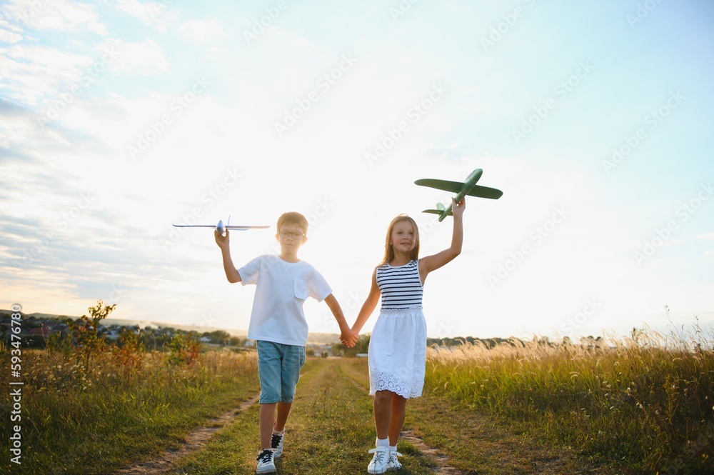 Obraz premium Active running kids with boy holding airplane toy.