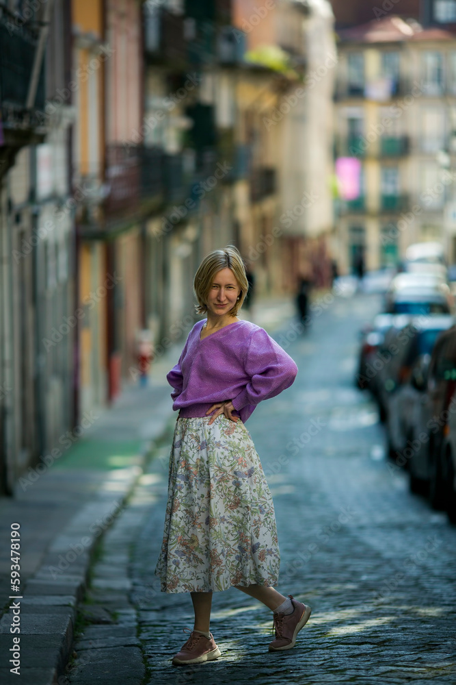 A woman in a skirt on the streets of downtown in Porto, Portugal.