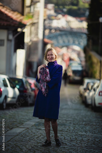 A woman walks down the street in Porto, Portugal.