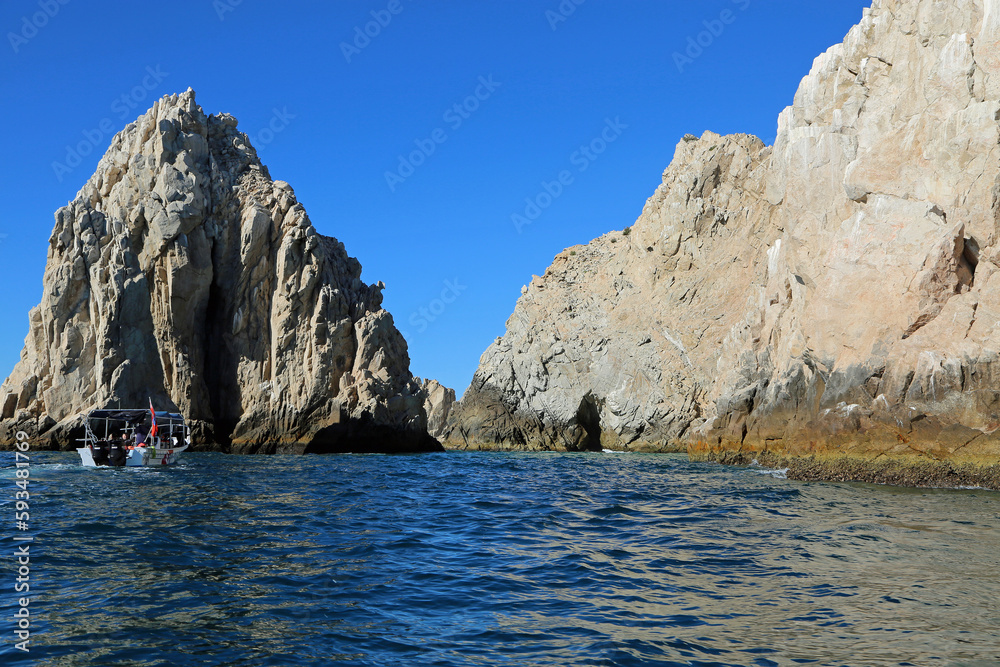 Fototapeta premium The boat and cliffs - Cabo San Lucas, Mexico
