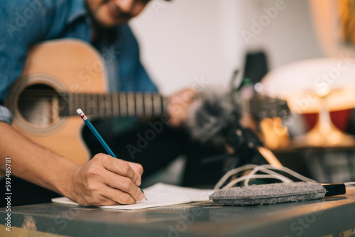 Fényképezés A songwriter or composer, Close up of songwriter hands composing sheet music writing on paper Professional songwriter with audio recorder digital music production