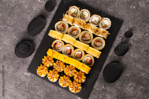 Sushi rolls set on dark background. Japanese and asian food concept