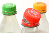 Bottle tethered cap is together with plastic bottle. Editorial illustrative image of environment friendly recycling. Text on cover 