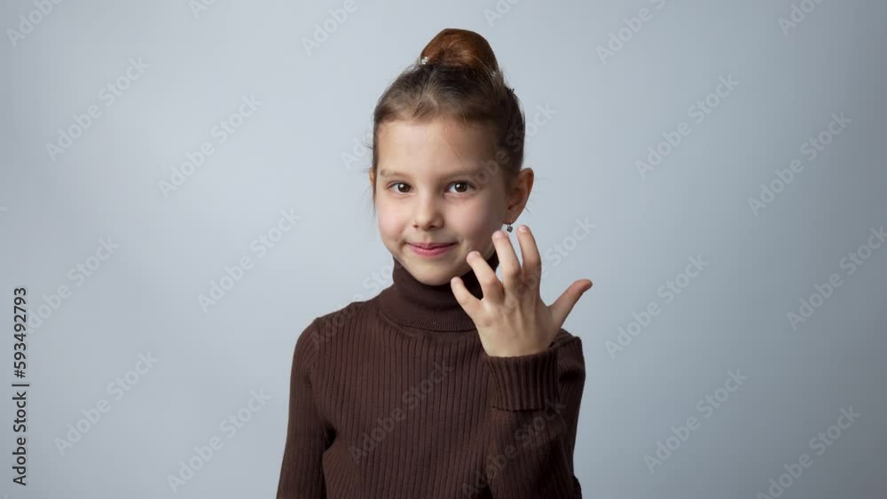 Little girl inviting someone to come, grey background