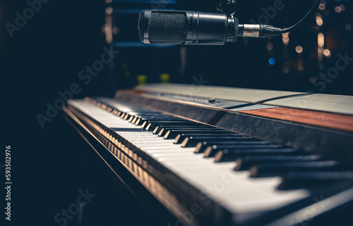 Music keys and a microphone on a dark background. © puhimec