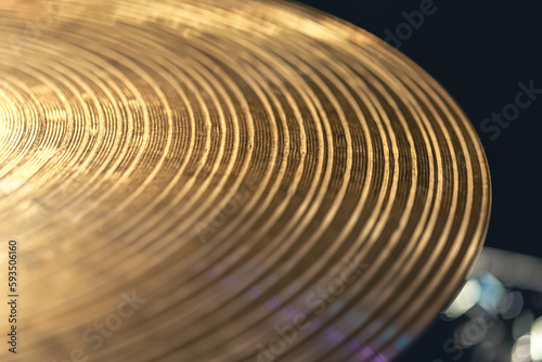 Drum cymbal close-up on a dark background.