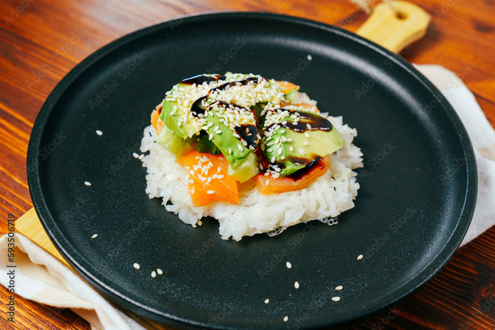 Sushi waffle is a cooking process. Culinary trend made with crispy rice waffles and sprinkled with salmon, cucumber Sushi waffle is a cooking process. Culinary trend made with crispy rice waffles and sprinkled with salmon, cucumber