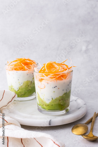 Healthy breakfasts and lunches, avocado and yogurt with chia, grated carrots and radishes in glass cups