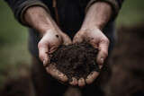 Harvesting the Earth: Two hands holding a pile of soil
