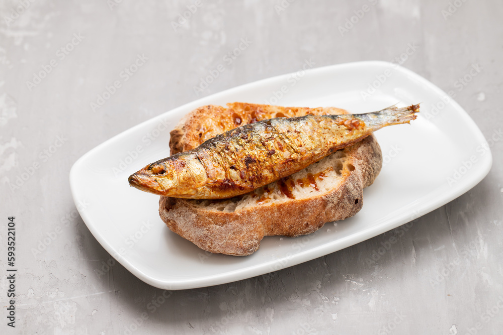 Grilled sardines with sauce on fresh bread Grilled sardines with sauce on fresh bread