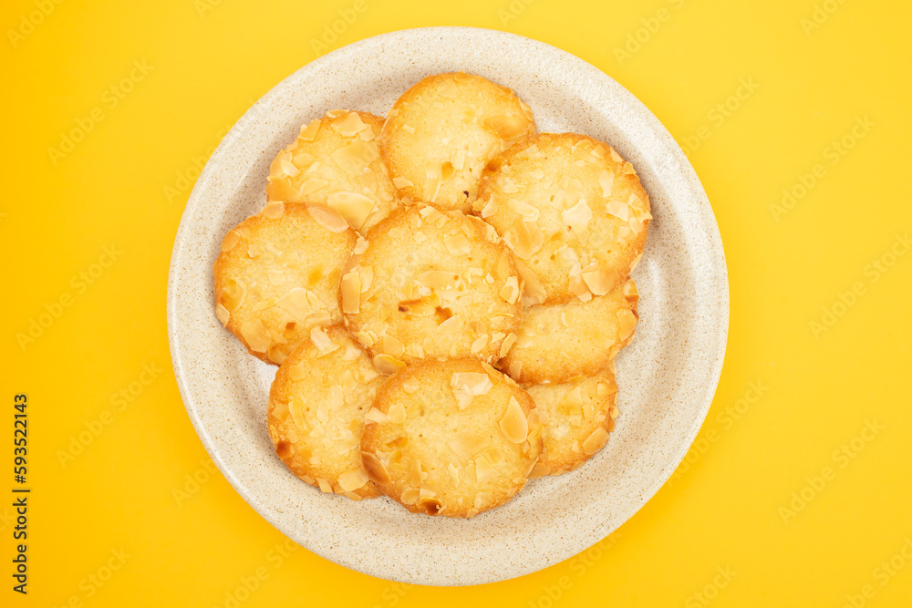 Few homemade cookies with almond on small dish Few homemade cookies with almond on small dish