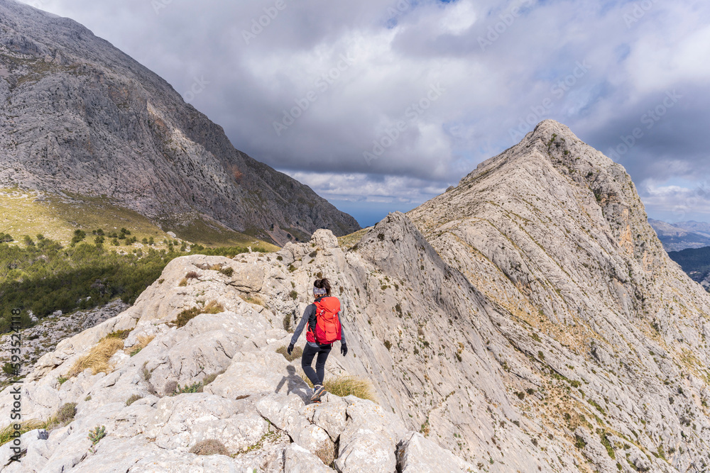 hiker on the crest of Puig de Ses Vinyes, 1105 meters, sierra de tramuntana, Escorca, Majorca, Balearic Islands, Spain