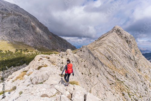 hiker on the crest of Puig de Ses Vinyes, 1105 meters, sierra de tramuntana, Escorca, Majorca, Balearic Islands, Spain