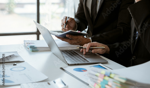 negotiation, analysis, discussion,asian male economist using report explaining the investment finance program to the company owner to plan marketing and hedging business risks.