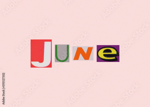 June word from cut out magazine colored letters on a light background