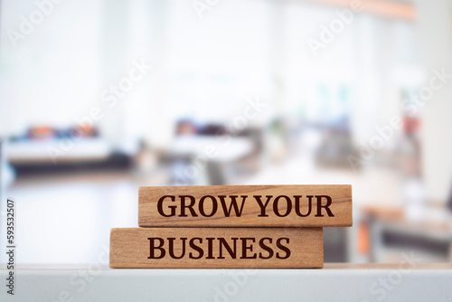 Wooden blocks with words 'GROW YOUR BUSINESS'.