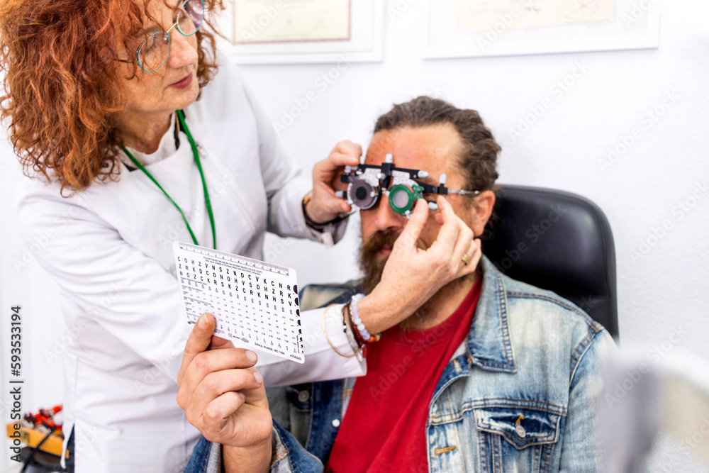 optometry concept - man having her eyes examined by an eye doctor