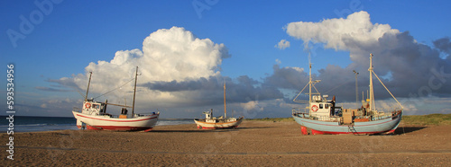 Summer clouds over fishing boats at the Slettestrand, Denmark. photo