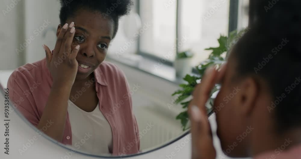Slow motion portrait of beautiful young woman touching soft skin looking at mirror in bathroom. Attractive lady enjoying stylish look and smiling. Slow motion portrait of beautiful young woman touching soft skin looking at mirror in bathroom. Attractive lady enjoying stylish look and smiling.