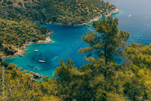 Amazing view of turquoise Coast in beach resort in the Fethiye district - Oludeniz. Turkey. Summer landscape with mountains, green forest, deep lagoon in bright sunny day. Travel background.