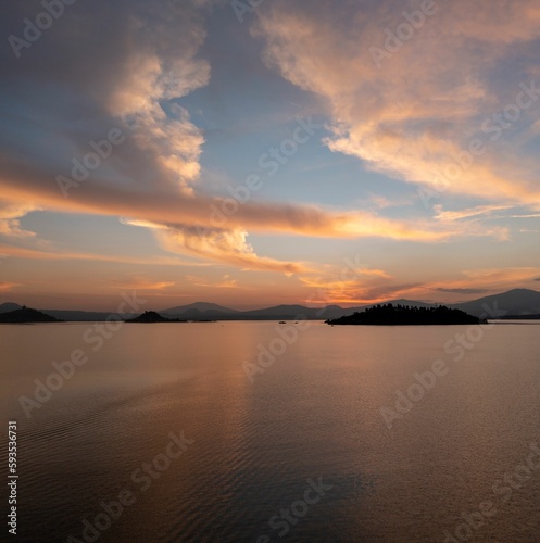 High-angle view of the sunset in a yellow sky from the seawater.