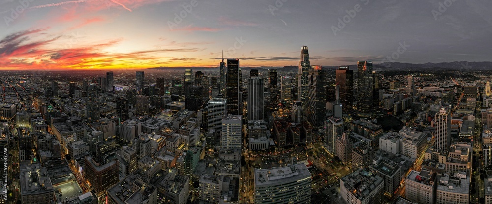 Aerial view of cityscape Los Angeles surrounded by buildings during sunset