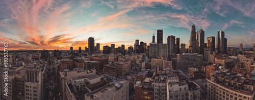 Aerial view of cityscape Los Angeles surrounded by buildings during sunset © Savagesage/Wirestock Creators