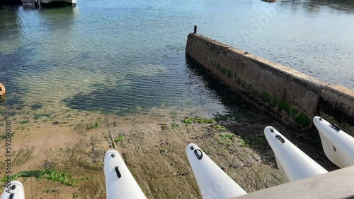 Kayaks stored on the slipway during low tide photo