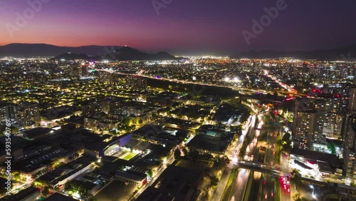 Futuristic night time Santiago, Chile central highway city landscape hyperlase aerial view flying towards Merino Benitez airport skyline photo