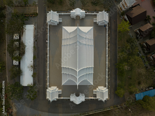 Chonburi, March 12, 2023. Wat Phon Prapa Nimit, This striking white Buddhist temple in a tranquil setting features a silver and mirrored interior. photo