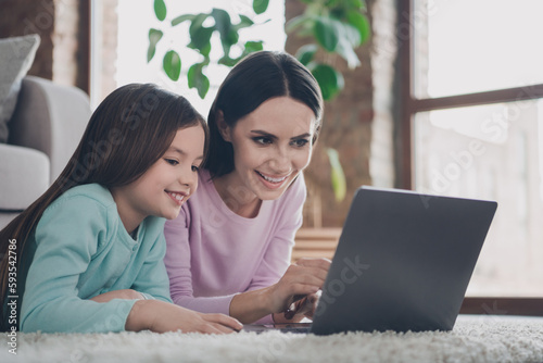 Photo of cute shiny mother daughter wear casual outfits preparing homework modern device indoors house room
