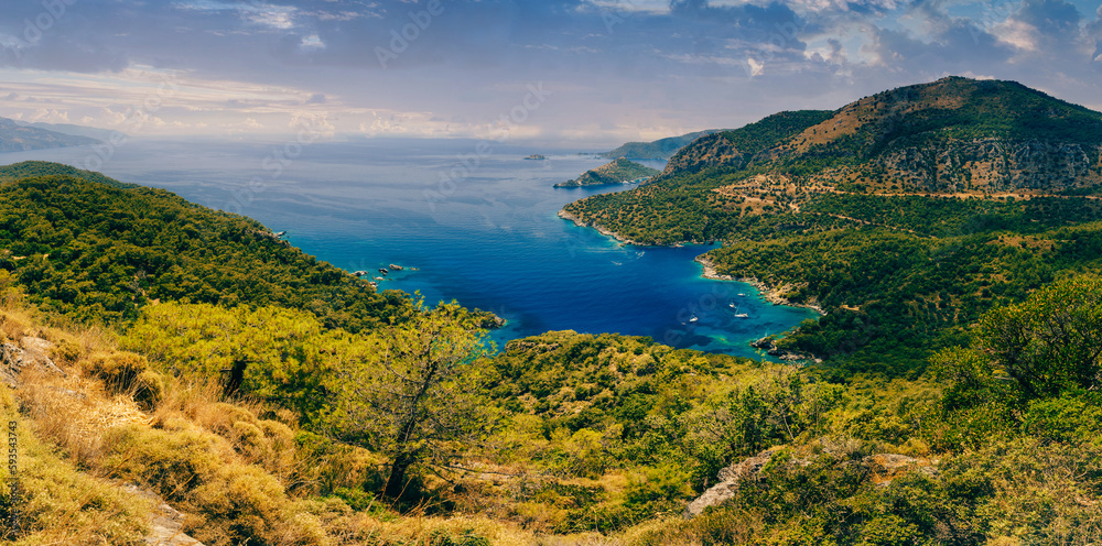 Amazing panoramic view of turquoise Coast in the Fethiye district -  beach resort Oludeniz. Turkey. Summer landscape with mountains, green forest, deep lagoon in bright sunny day. Travel background.