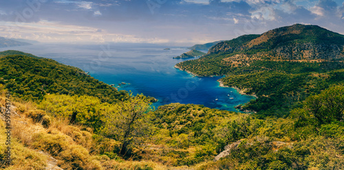 Amazing panoramic view of turquoise Coast in the Fethiye district - beach resort Oludeniz. Turkey. Summer landscape with mountains, green forest, deep lagoon in bright sunny day. Travel background.