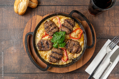 Meatballs with alinazik sauce. Traditional turkish meatballs on eggplant puree in cast iron skillet photo