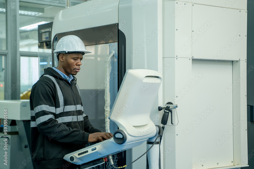 Engineer operating CNC computer machine working in industry factory. Engineer operating CNC computer machine working in industry factory.