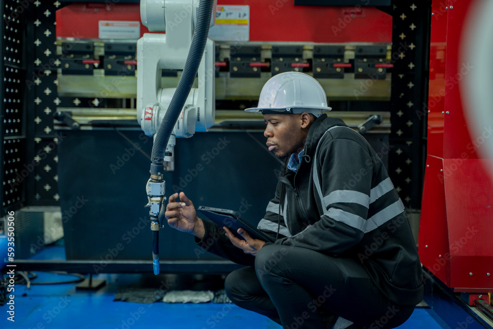 Engineers solve problems control panel of robot for setting programming for industrial robot arm controller in production plant factory. Engineers solve problems control panel of robot for setting programming for industrial robot arm controller in production plant factory.