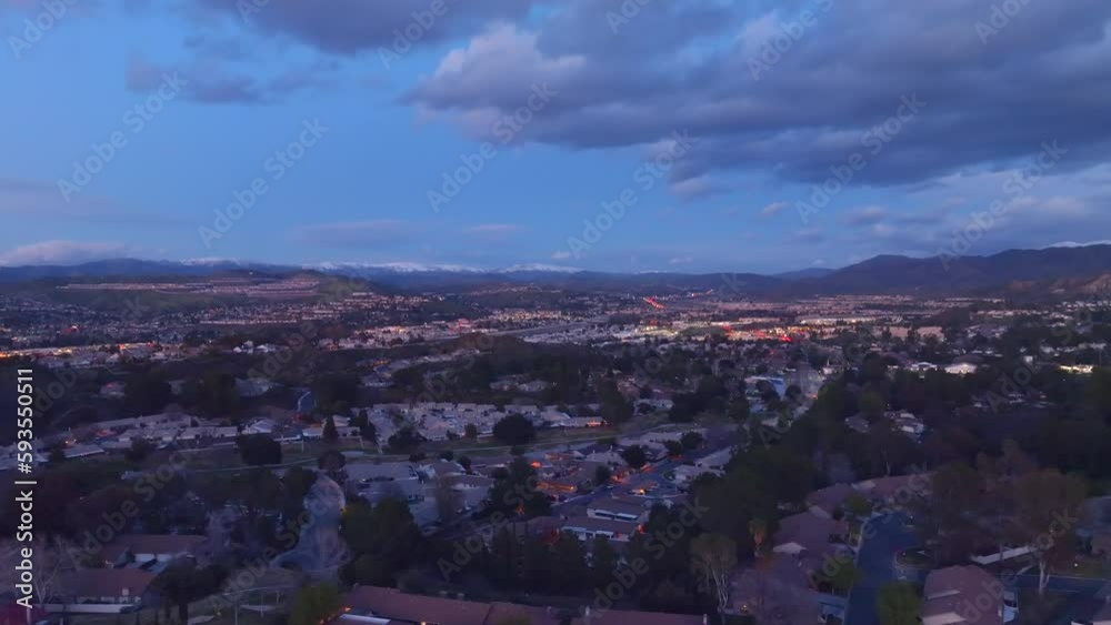 Aerial view flying over Santa Clarita California neighbourhood suburbs under cloudy night sky Aerial view flying over Santa Clarita California neighbourhood suburbs under cloudy night sky