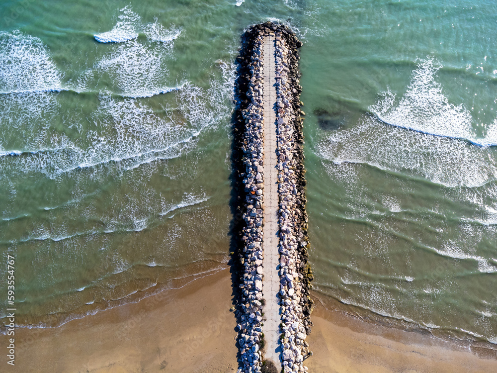 Aerial view landscape Italy Pescara. Sea, waves, breakwater, stones, rocks, beach, sand, empty.