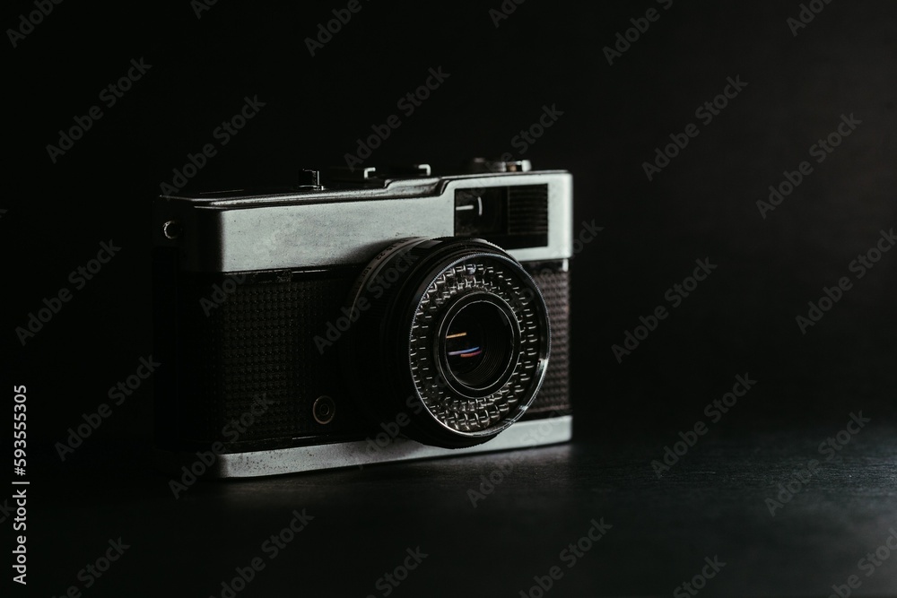Close-up shot of an old retro film camera on dark background