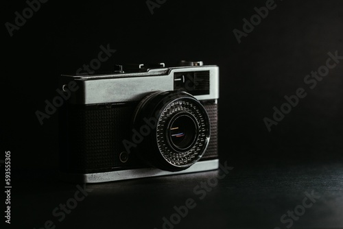 Close-up shot of an old retro film camera on dark background