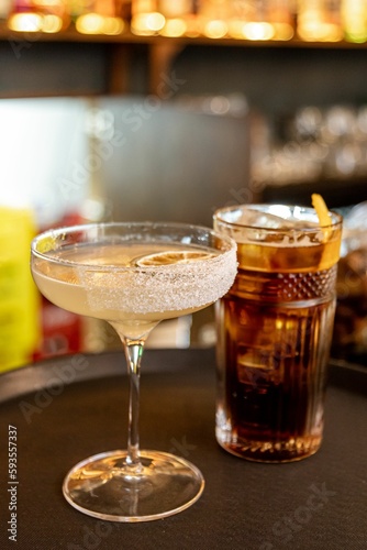 Vertical closeup of two alcoholic cocktails on a tray. Margarita and Americano. © Mauricio Darias/Wirestock Creators
