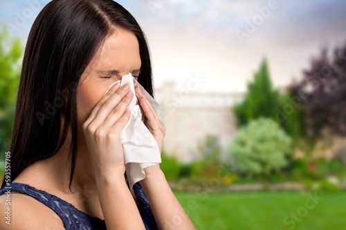 Young woman has allergy sneezing.