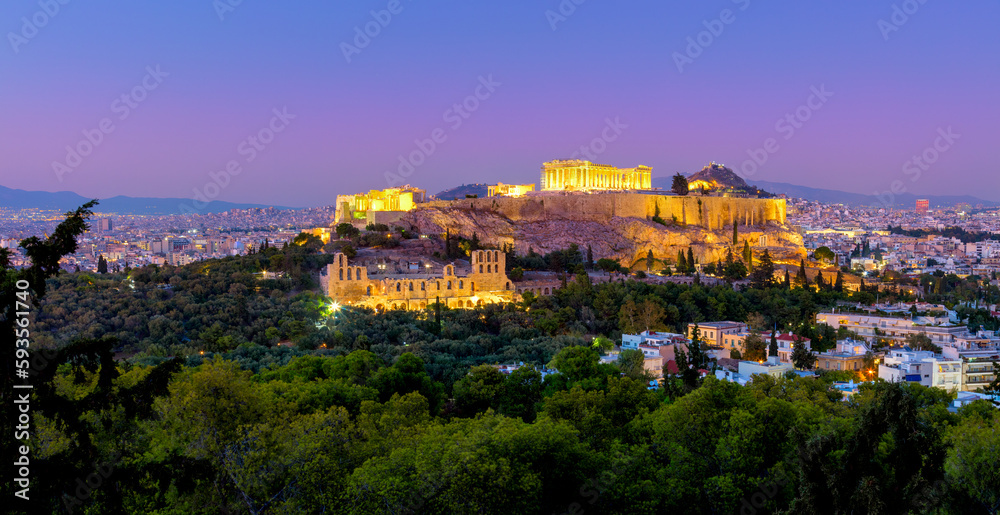Greece - The Acropolis of Athens, Greece, with the Parthenon Temple with lights during sunset. Athens, Greece, Europe