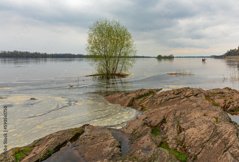 Flooding in Ukraine in April 2023. Spring flood on the Dnieper River. The water level rises and floods the shore