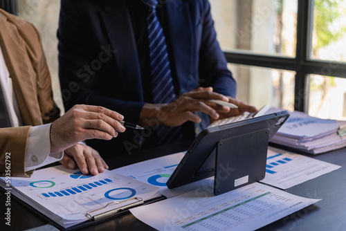 accountant working on desk using calculator for calculate finance report in office Business accounting concept, Business man using calculator with computer laptop, budget and loan paper in office.